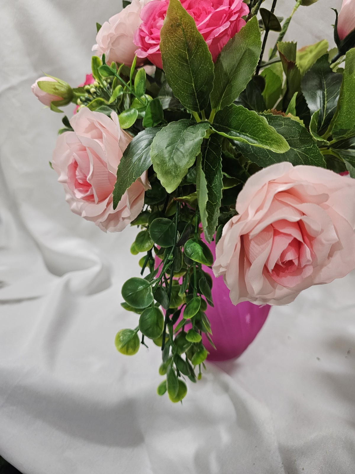 Varied Colors of soft Pink Artificial Roses in a beautiful pink vase