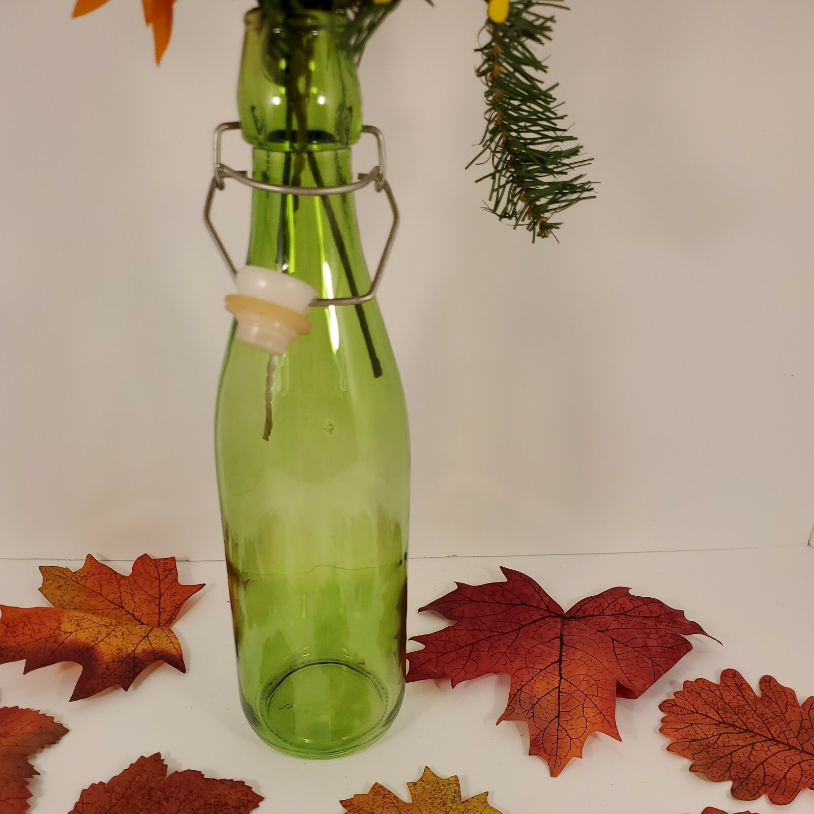 Fall Floral In Green Seal Cap Bottle with Leaves Arrangement Centerpiece