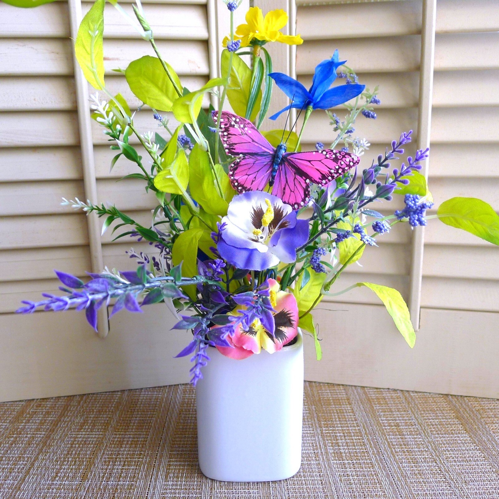 Wildflower Pansy Floral Arrangement Pink Feather Butterfly and a White Planter