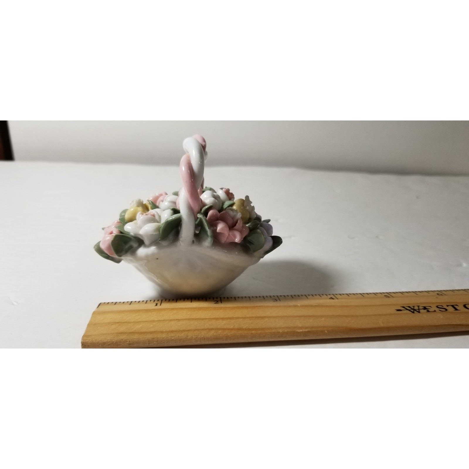 Three inch by 3 inch hand painted porcelain basket (1.1282)