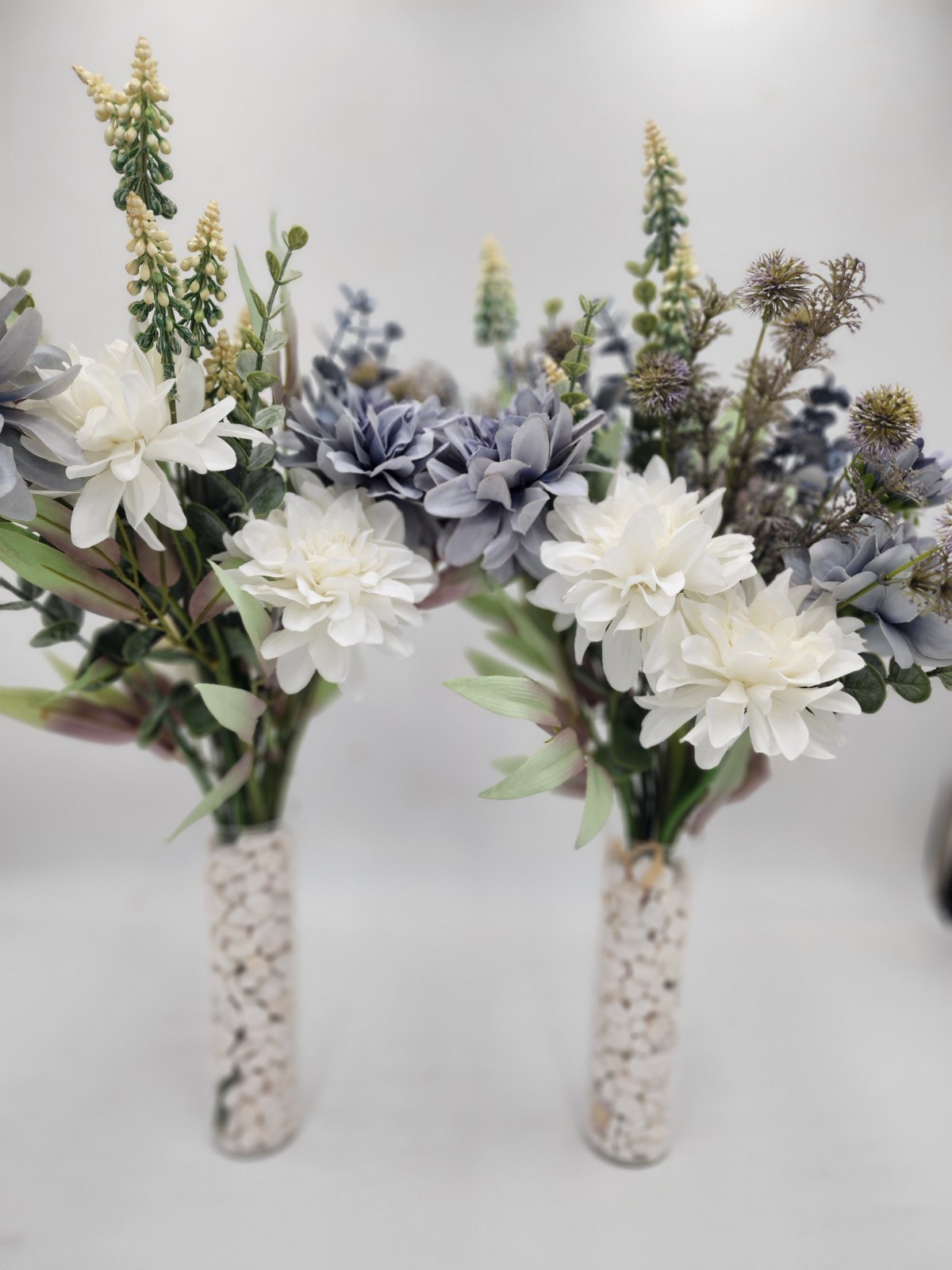 2 beautiful flower arrangements with vases included blue and white stands 20″