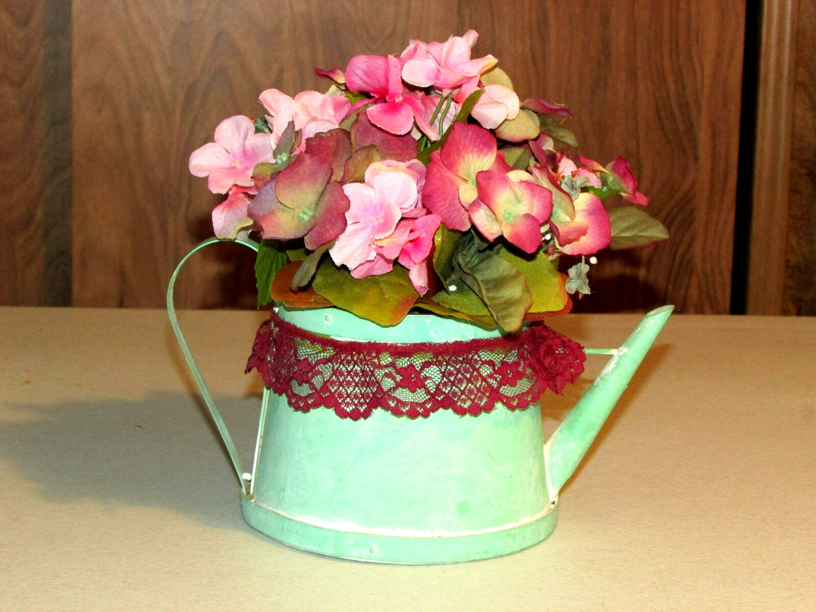 green cardboard WATER PAIL w/artificial FLOWERS 9x6x10″ overall (bdrm)