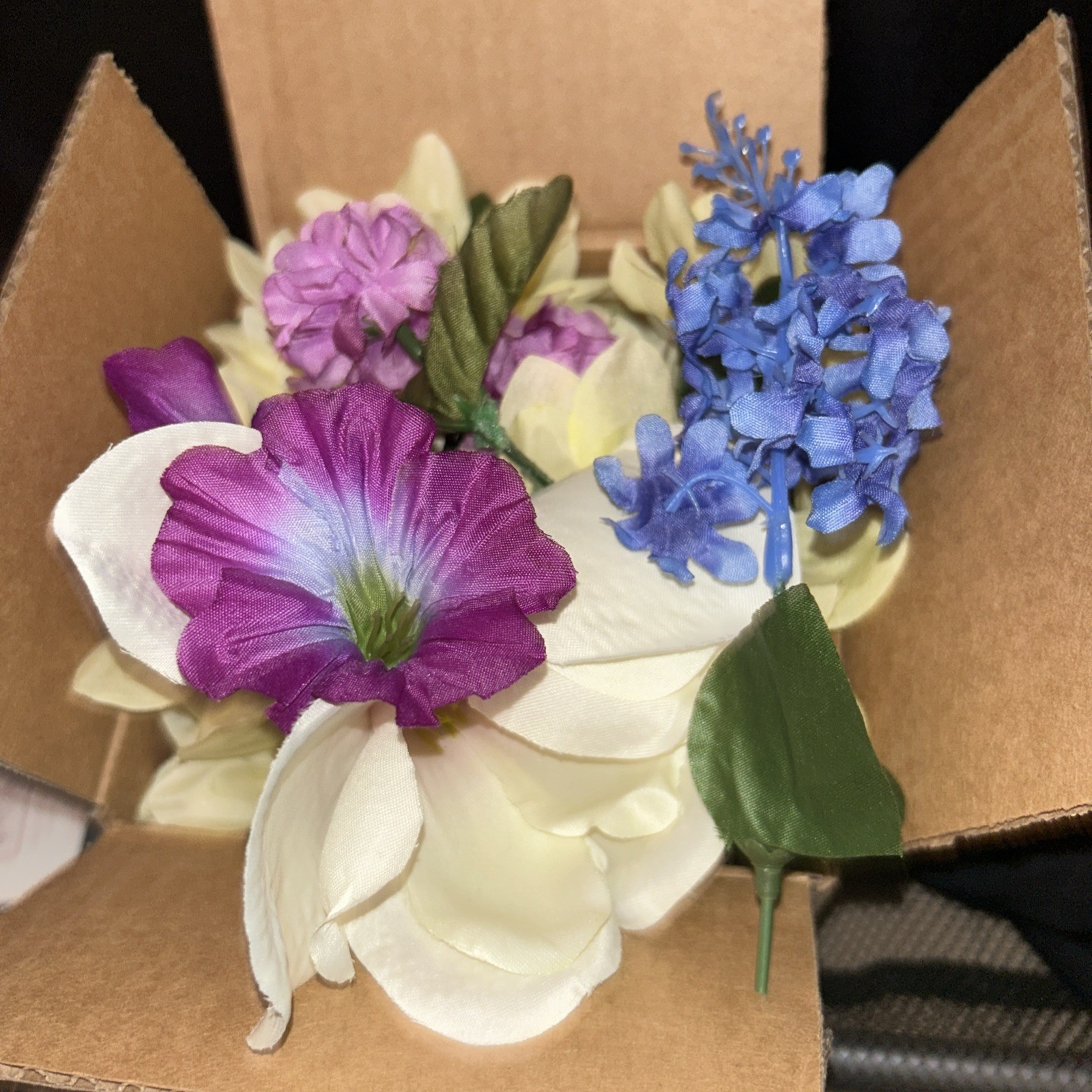 Box Full Of Fake Flowers Purple Blue And White Off White With Stems And Green