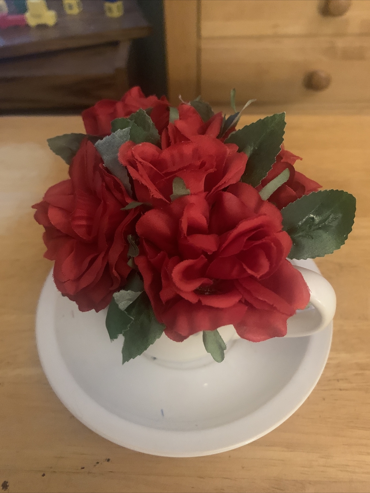 Artificial Red Flowers in Tea Cup and Saucer