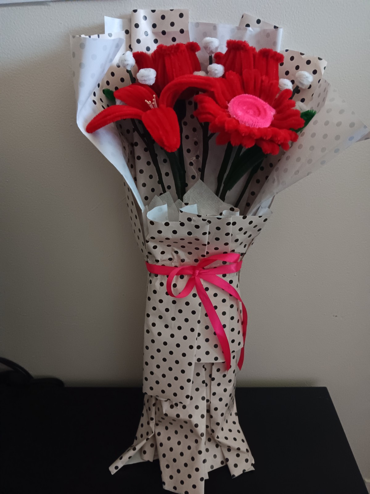 Handmade Flower Bouquet with red roses, a lily and a daisy.