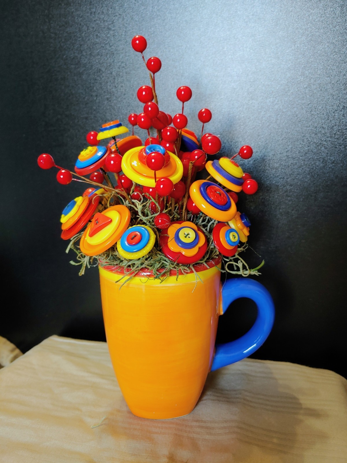 Bright Button Bouquet in Orange Coffee Mug. Red, orange, yellow. fun and playful