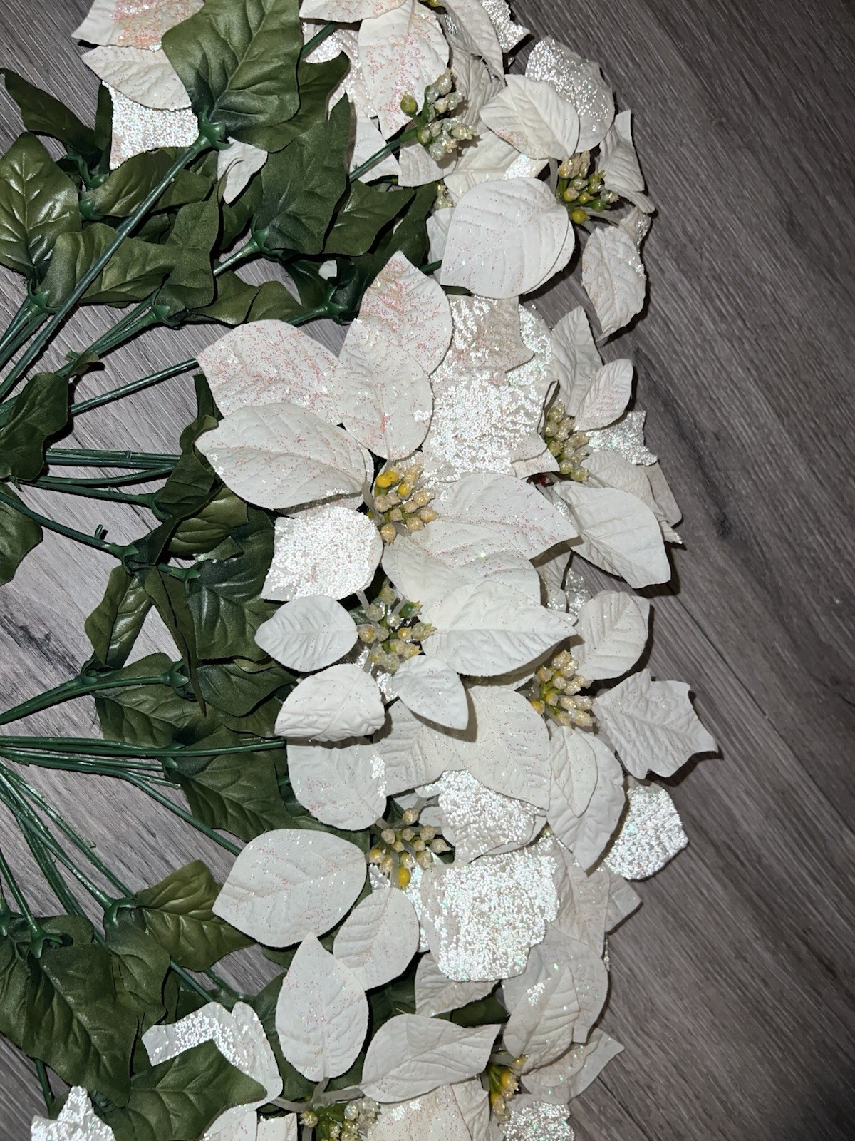 2 artificial white poinsettia bushes with green leaves and sparkle details
